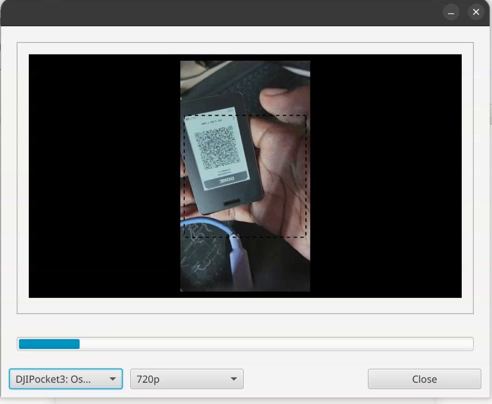 Sparrow webcam window with the ERA held up, its link QR inside the dotted frame.