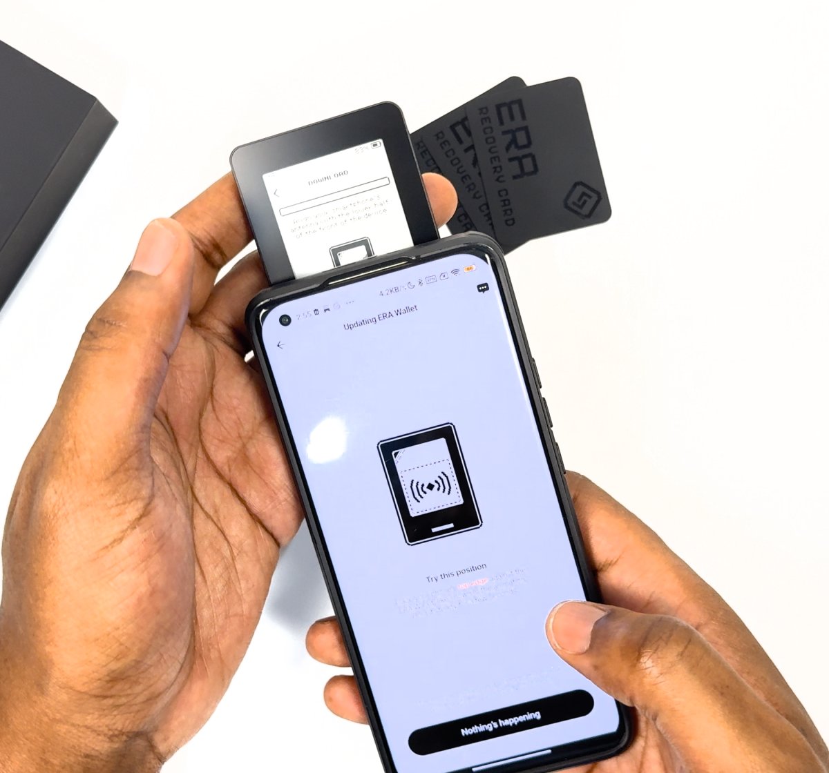 Phone held face-up over the ERA with its top edge across the lower half of the device front