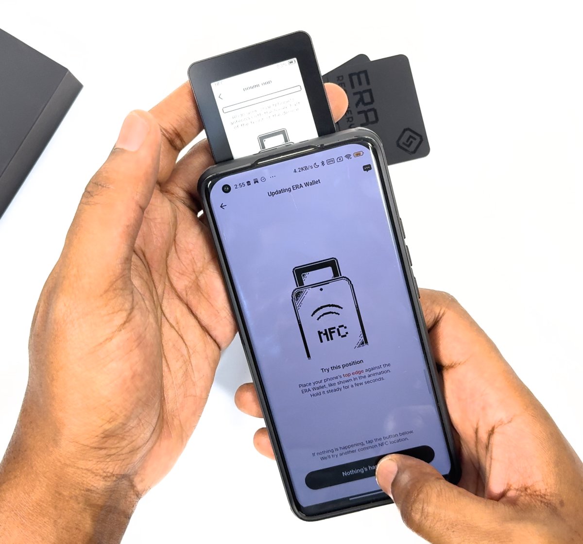 Phone held face-up over the ERA, its top edge across the lower half of the device