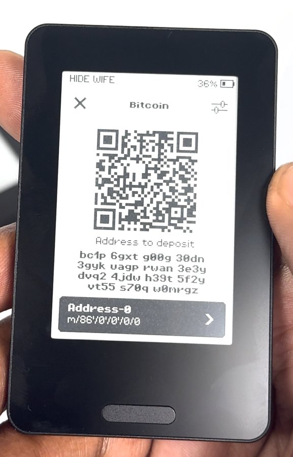 Device photo: Bitcoin deposit screen with a Taproot bc1p address and the path m/86'/0'/0'/0/0.